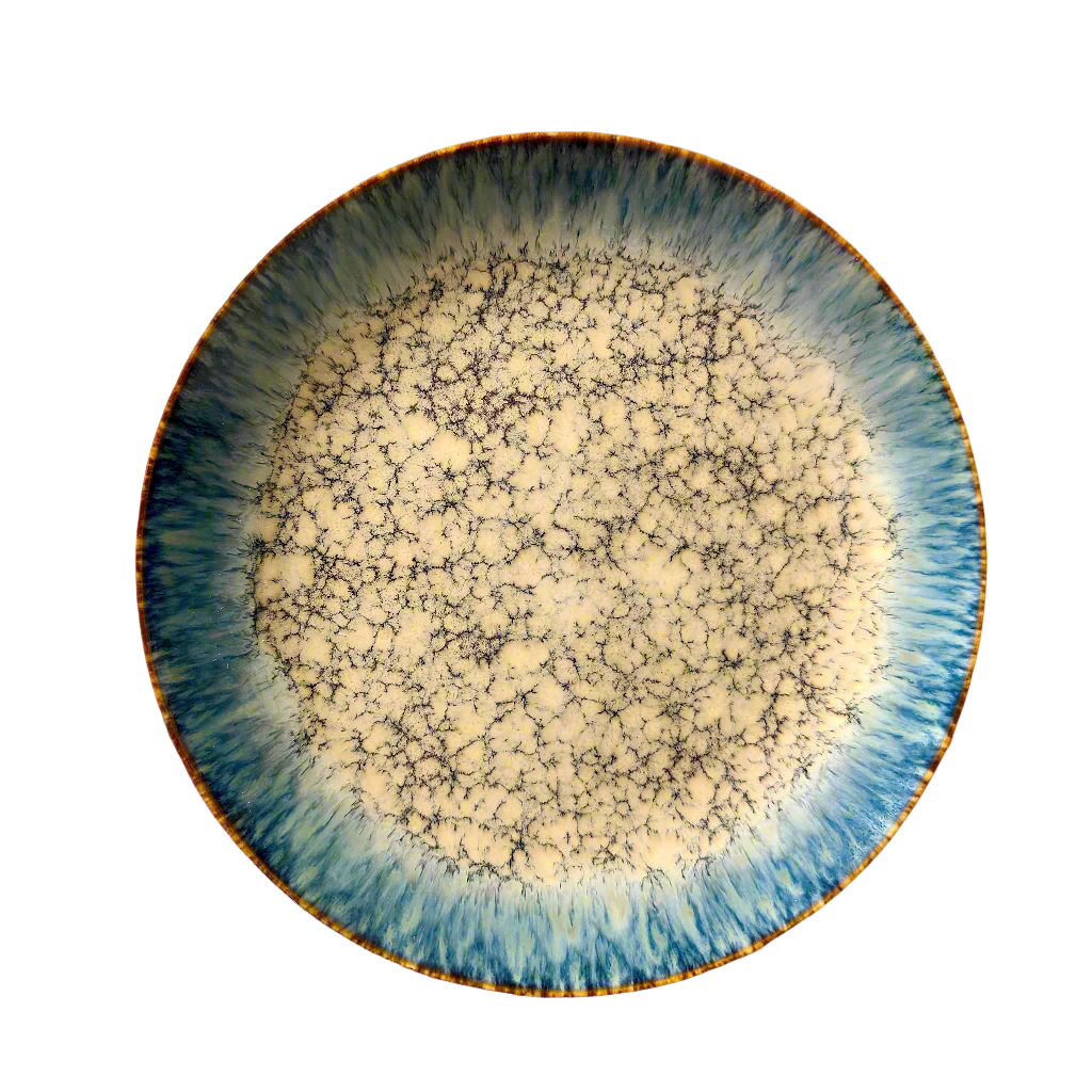 Ceramic plate with blue and gold rim on a white background