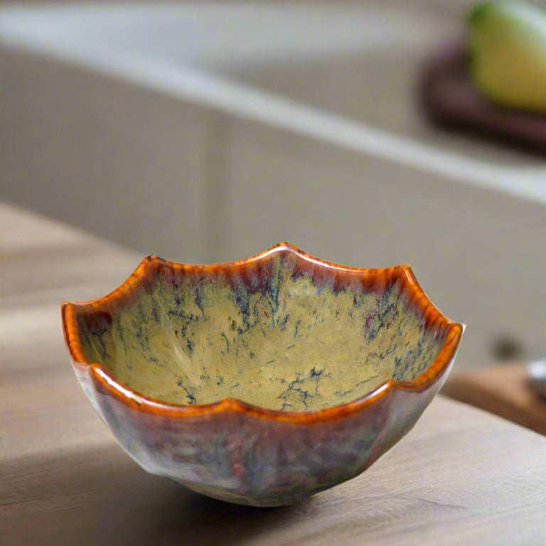 Ceramic bowl with a textured surface on a patterned tablecloth