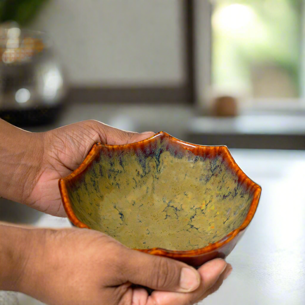 Hand holding a ceramic bowl with a textured surface