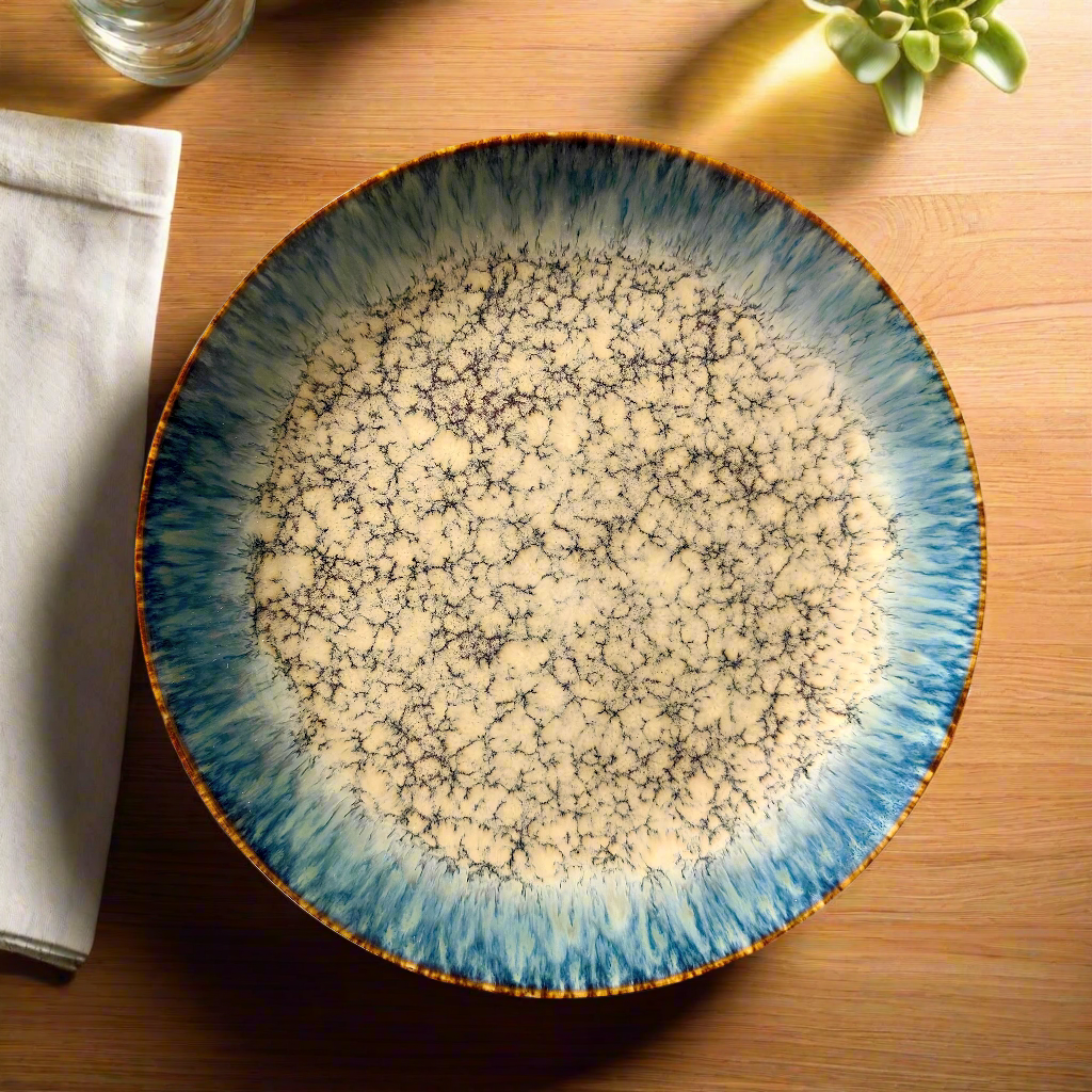 Ceramic plate with blue and white speckled design on a wooden table