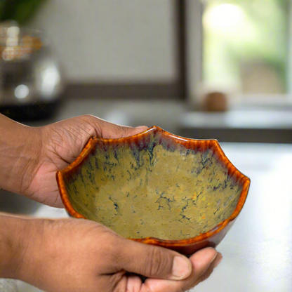 Hand holding a ceramic bowl with a textured surface